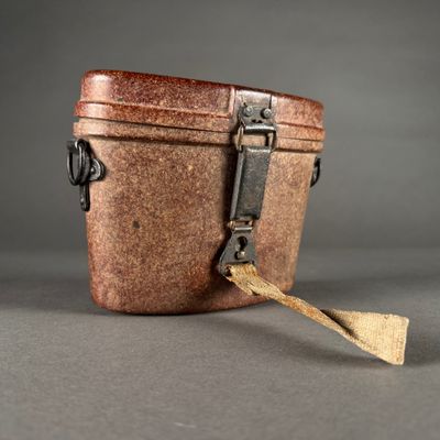 a small brown box with a wooden spoon in it