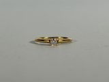 a close up of a gold ring with a diamond on it