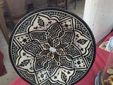 a black and white plate sitting on a red table