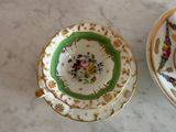 two cups and saucers sitting on a marble table