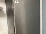 a stainless steel refrigerator in a kitchen next to a sink