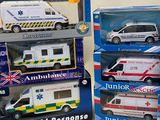 several toy ambulances are stacked on top of each other on a table