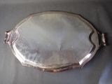 a silver plate with a handle on it on a table