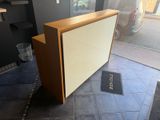 an image of a reception desk with a door open