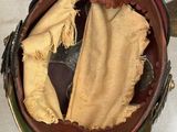 an old helmet with a cloth inside of it