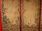 a room divider with a red curtain behind it