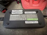 a battery that is connected to a charger on the floor
