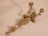 a gold colored candle holder with a bird on it