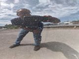 a reflection of a man in the mirror of a car