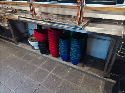 many bowls and pans on the counter in the kitchen