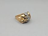 a close up of a gold ring with a skull on it