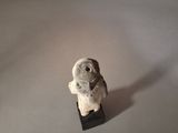 a figurine of a bird sitting on top of a table