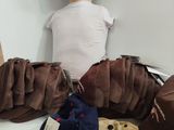 a doll with sunglasses and a hat on a bed