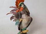 a figurine of a rooster on a pedestal