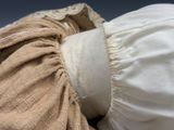 a close up of a white shirt with a ruffle on it