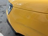 a yellow car parked on the side of the street