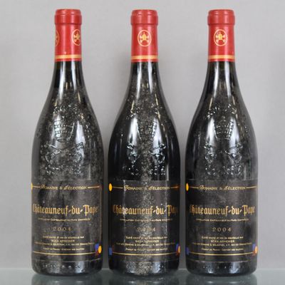 three bottles of red wine sitting on top of a glass table