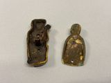two pieces of bronze are sitting on a white surface