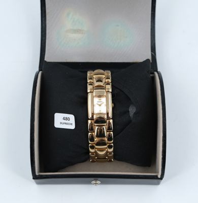 an image of a gold watch in a box with a bow tie