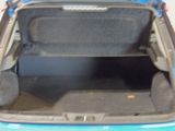 the back of a car with its trunk open and the seat folded down