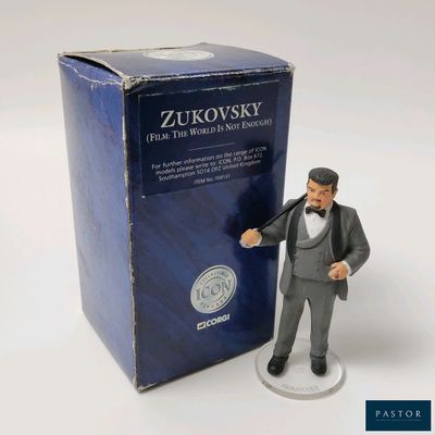 figurine of a man in a tuxedo suit and top hat holding a baseball bat