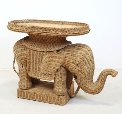 a wicker elephant with a basket on top of it