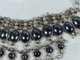 a close up of a necklace on a table