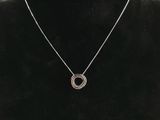 a necklace on a mannequin neck with a black background