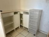 a small kitchen with white cabinets and a white counter top