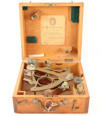 a wooden box with a pair of scissors in it