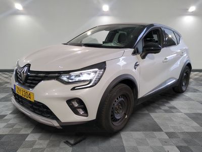 a white car parked in a room with a checkered floor