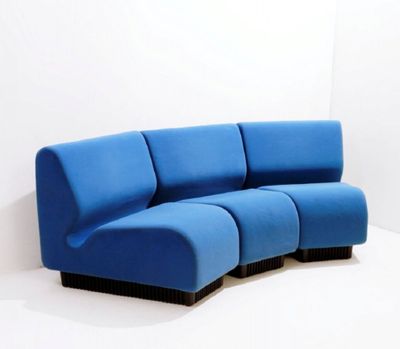 an image of a blue couch in a white room