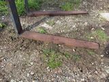 a rusted piece of metal in the middle of a field