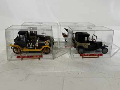 two toy cars in a clear box on a white surface