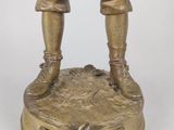 bronze figurine of a man in a baseball uniform holding a bat
