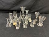 a lot of glass vases and glasses sitting on a table