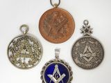 trois pendentifs argentés et bleus ornés de symboles maçonniques