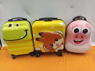 three pieces of luggage sitting next to each other on a bed