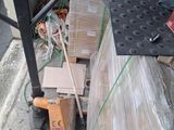 a pallet with a bunch of boxes on it on the side of the street