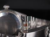 a close up of a watch with a chain around it