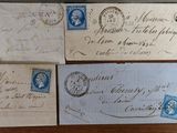 many old envelopes with stamps on them sitting on a table