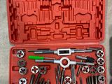 a red tool case with tools in it on the ground