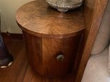a small table with a bowl on top of it next to a couch