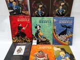 six children ' s books are lined up on a white surface