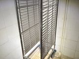 a metal rack that is in the corner of a room