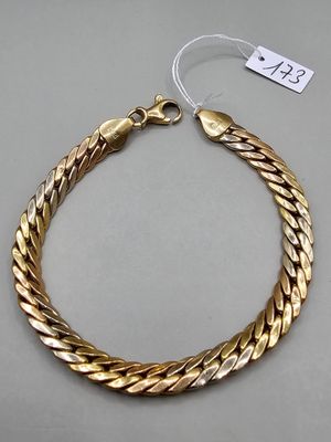 a gold bracelet with a clasp on a white background