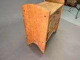 a small wooden cabinet with a drawer on top of it