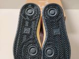 the bottom of a pair of black shoes on top of a cardboard box