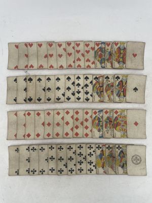 a close up of a group of playing cards on a white surface