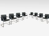 un lot de six chaises en cuir noir et chrome
